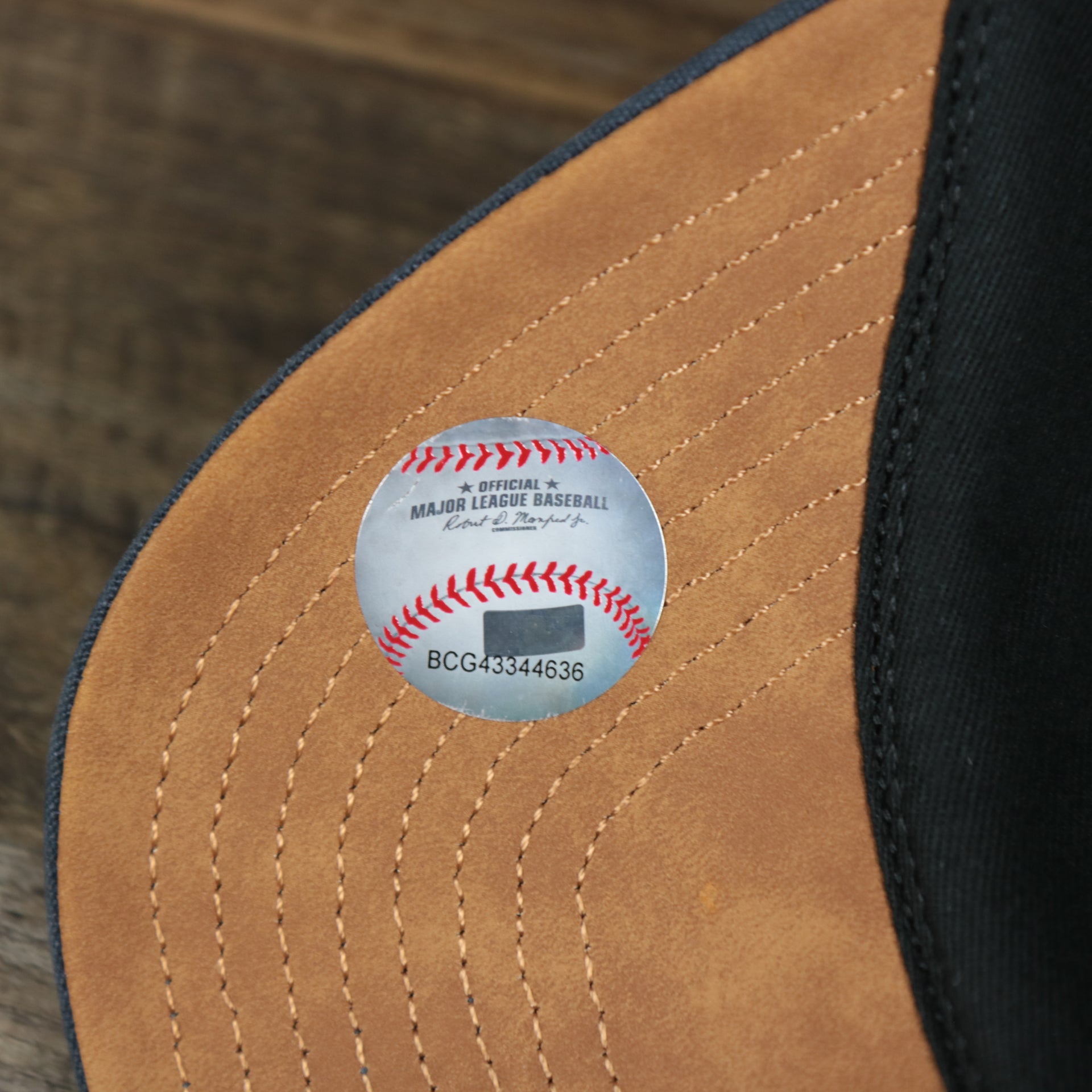 The MLB Baseball Sticker on the Cooperstown Houston Astros Cooperstown Collection Side Patch Leather Brown Undervisor Dad Hat | Vintage Navy Dad Hat