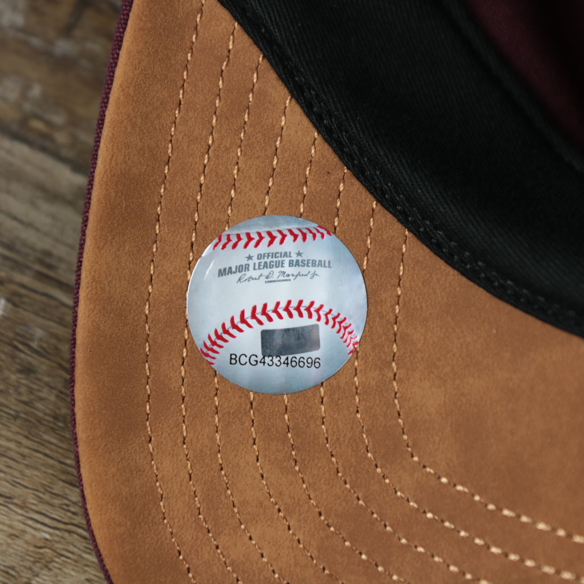 The MLB Baseball Sticker on the Cooperstown Philadelphia Phillies Cooperstown Collection Side Patch Leather Brown Undervisor Dad Hat | Maroon Dad Hat