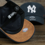 The Leather Undervisor on the Cooperstown New York Yankees Cooperstown Collection Side Patch Leather Brown Undervisor Dad Hat | Vintage Navy Dad Hat