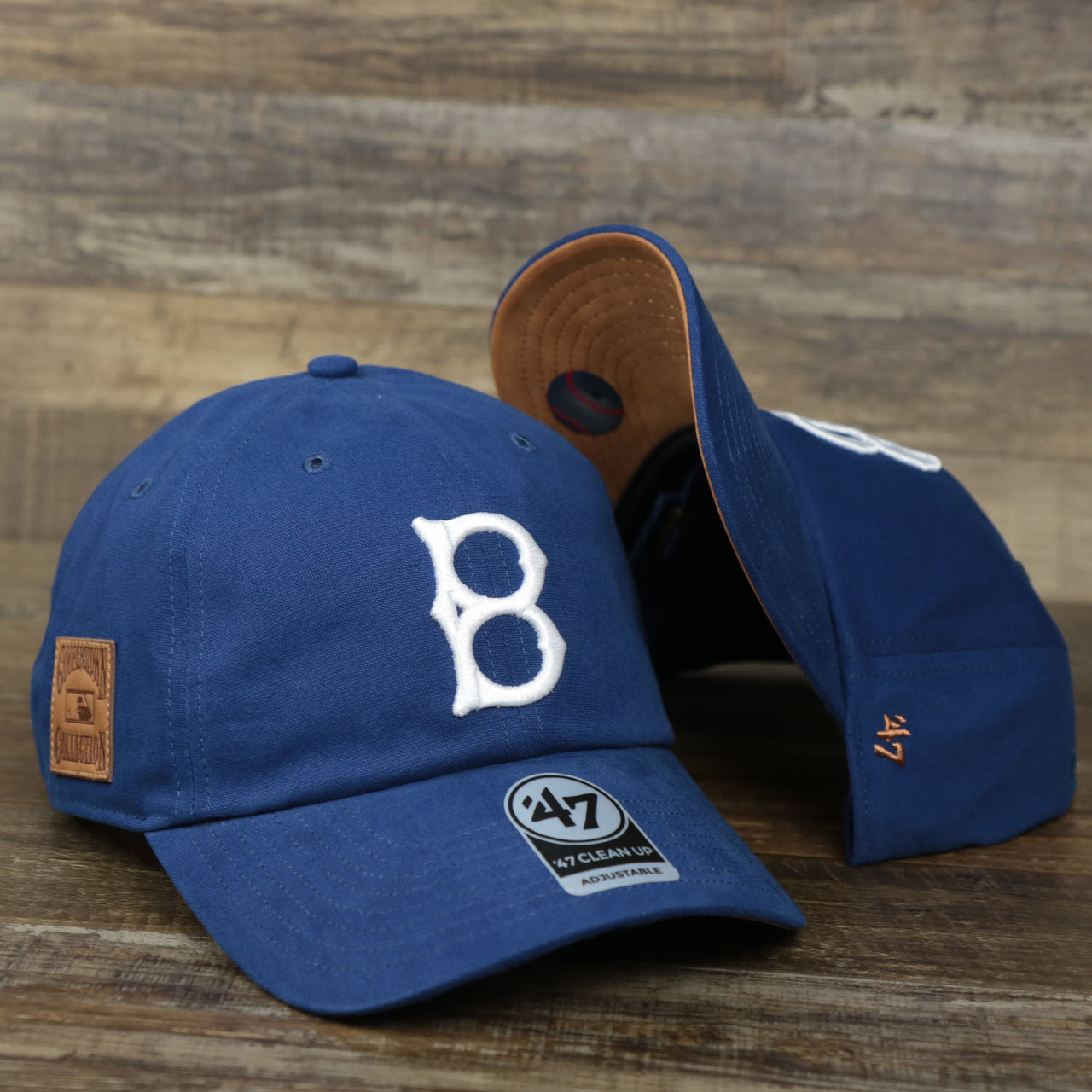 The Cooperstown Brooklyn Dodgers Cooperstown Collection Side Patch Leather Brown Undervisor Dad Hat | Vintage Royal Blue Dad Hat