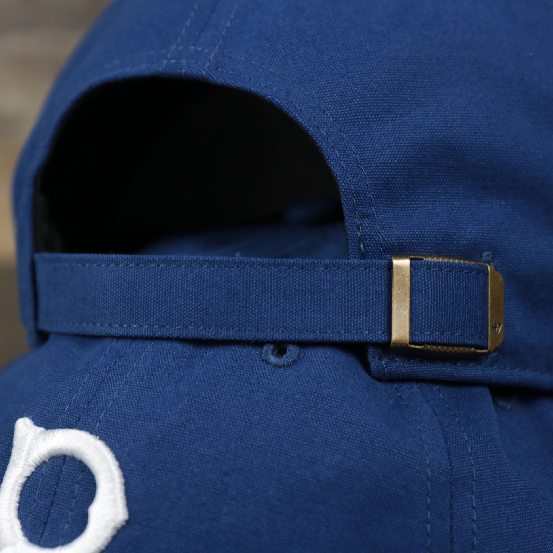 The Royal Blue Adjustable Strap on the Cooperstown Brooklyn Dodgers Cooperstown Collection Side Patch Leather Brown Undervisor Dad Hat | Vintage Royal Blue Dad Hat