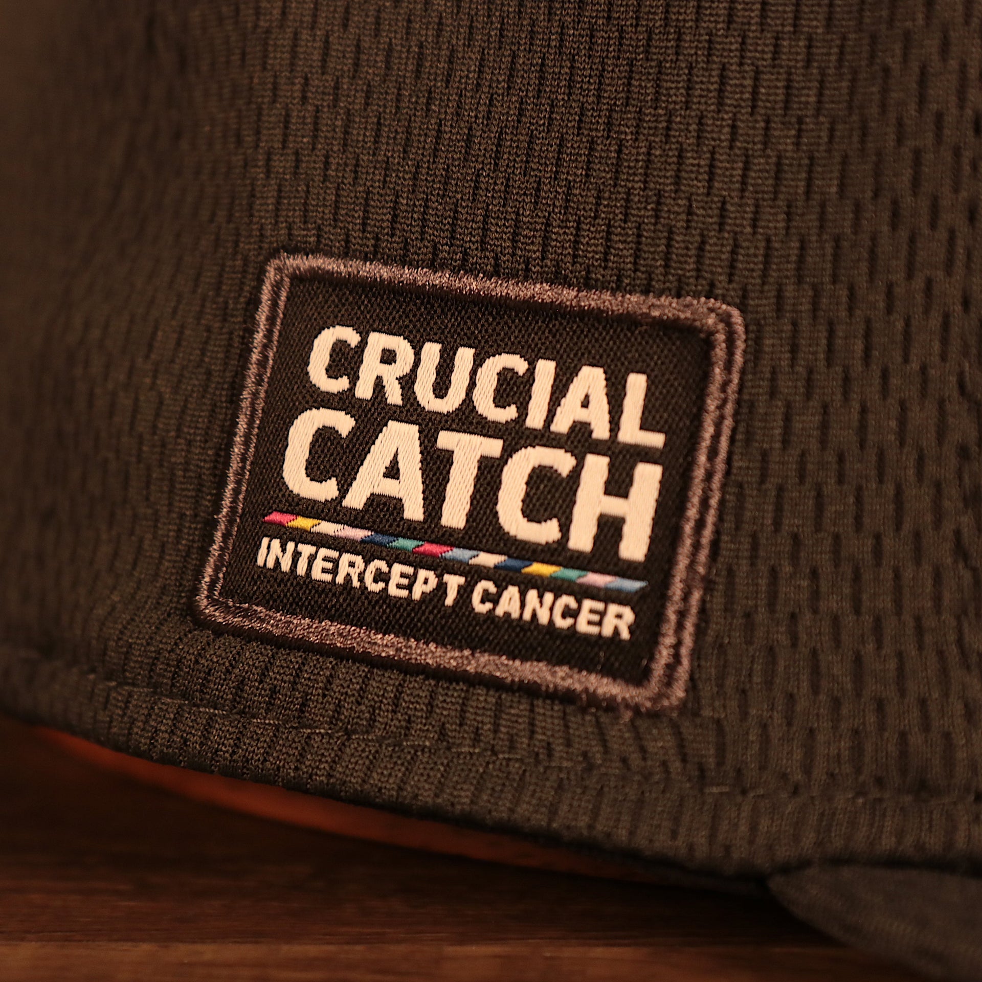 Close up of the side patch on the NFL Shield 2021 Crucial Catch Breast Cancer Awareness 9Fifty Snapback Hat
