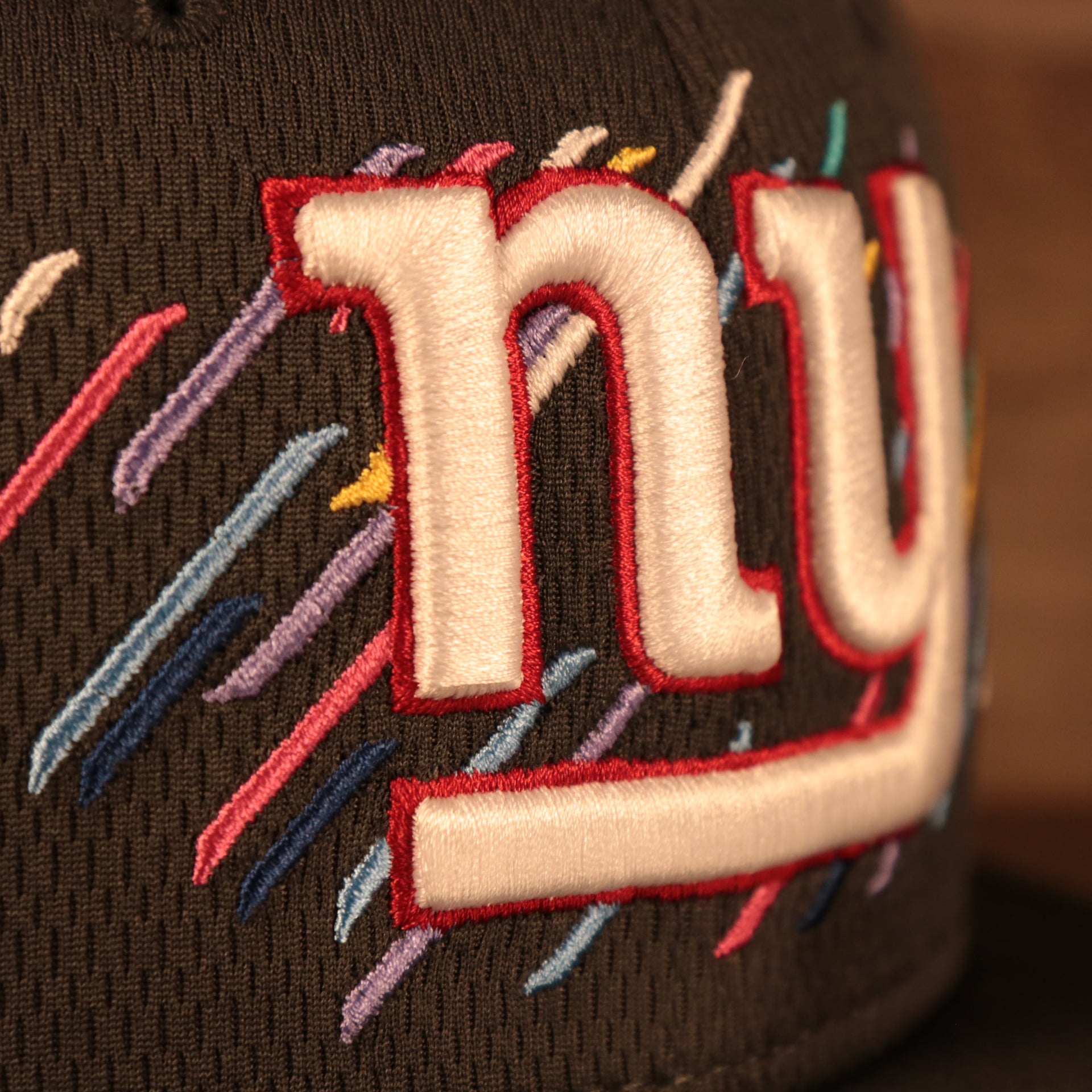 Close up view of the New York Giants logo on the "New York Giants 2021 Crucial Catch 9Fifty Snapback Hat"