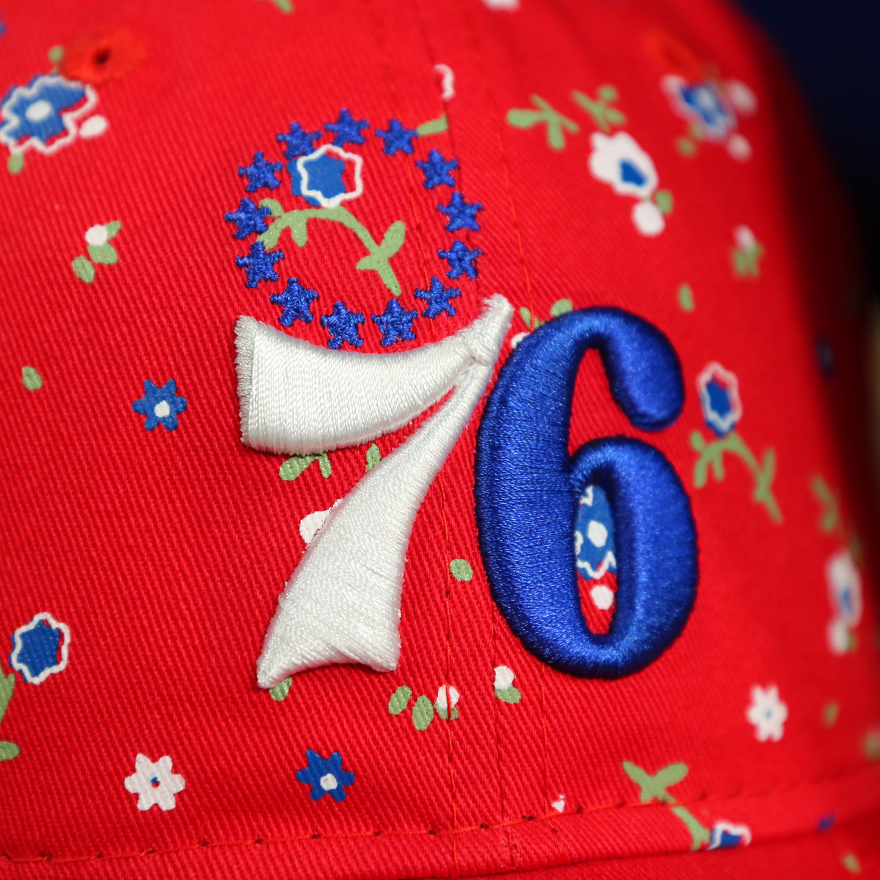 close up of the 76ers logo on the Philadelphia 76ers Ladies Floral Bloom Micro Flower Pattern 9Twenty Dad Hat | Womens Floral 76ers Hat