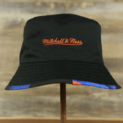 mitchell and ness logo on the New York Knicks 90s Inspired NBA Hyper Mitchell and Ness Reversible Bucket Hat