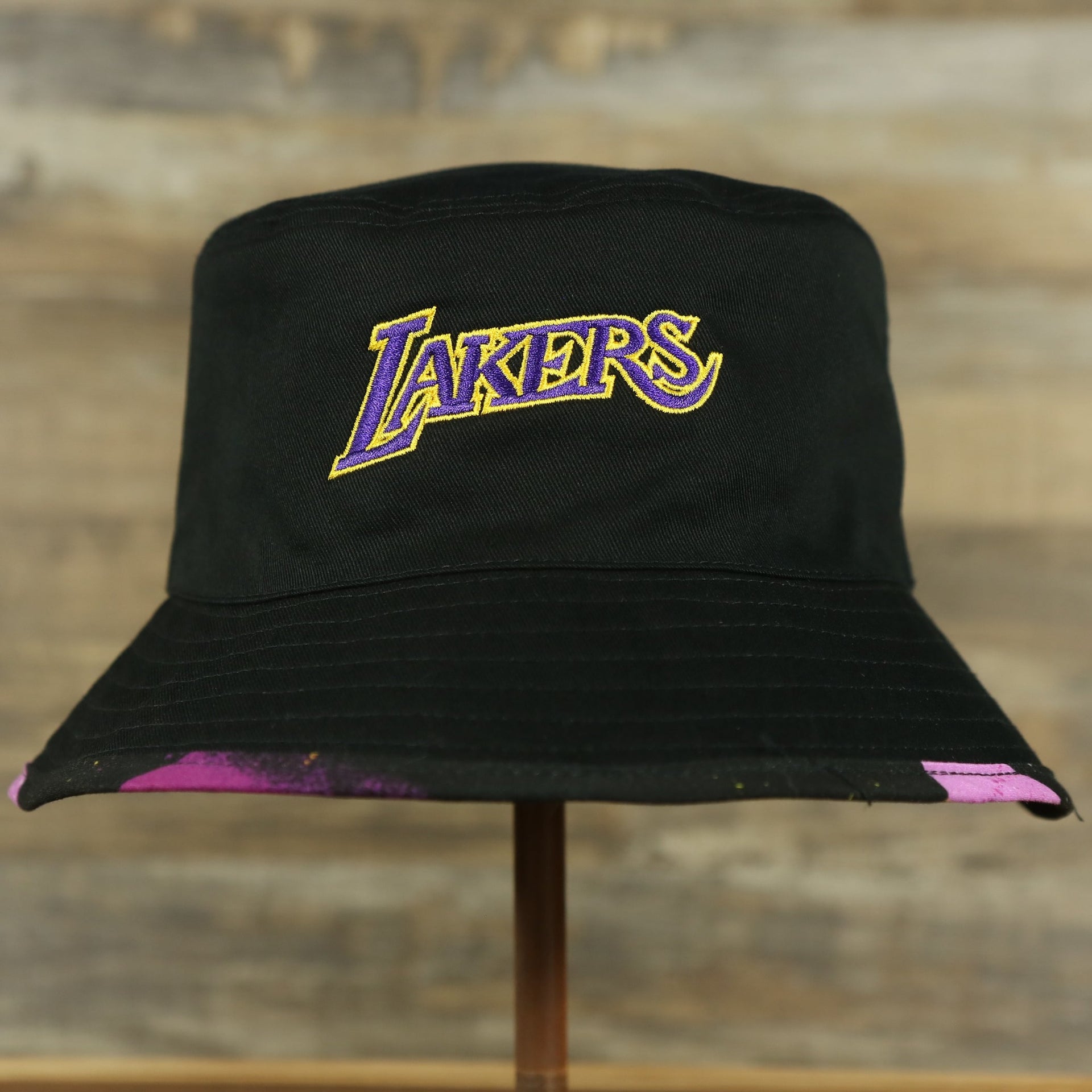 lakers logo on the Los Angeles Lakers 90s Inspired NBA Hyper Mitchell and Ness Reversible Bucket Hat
