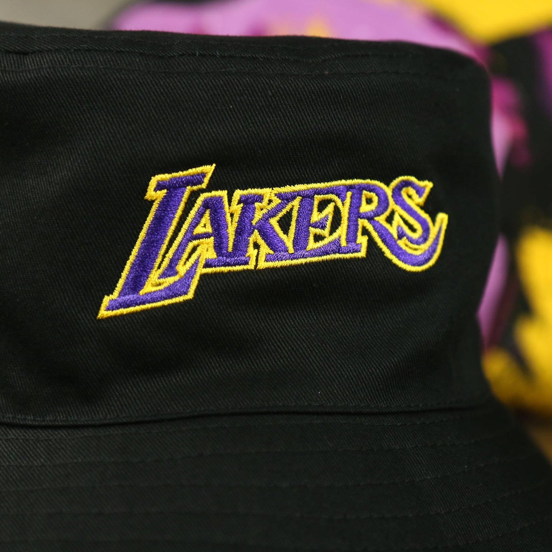 lakers logo on the Los Angeles Lakers 90s Inspired NBA Hyper Mitchell and Ness Reversible Bucket Hat