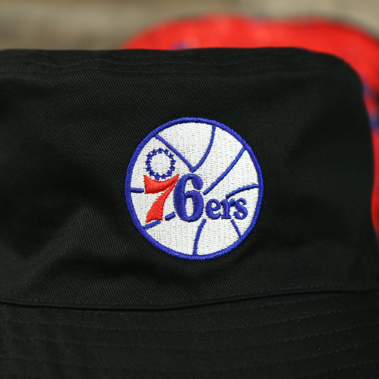 76ers logo on the Philadelphia 76ers 90s Inspired NBA Hyper Mitchell and Ness Reversible Bucket Hat