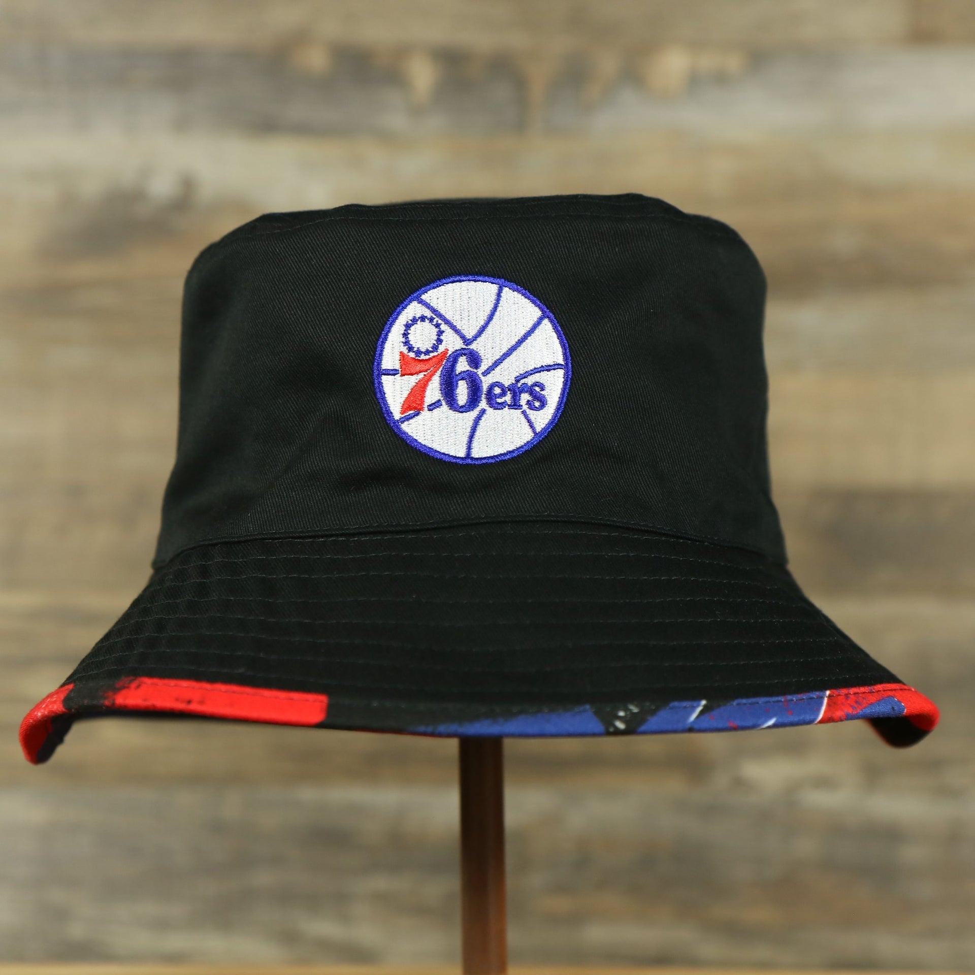 76ers logo on the Philadelphia 76ers 90s Inspired NBA Hyper Mitchell and Ness Reversible Bucket Hat