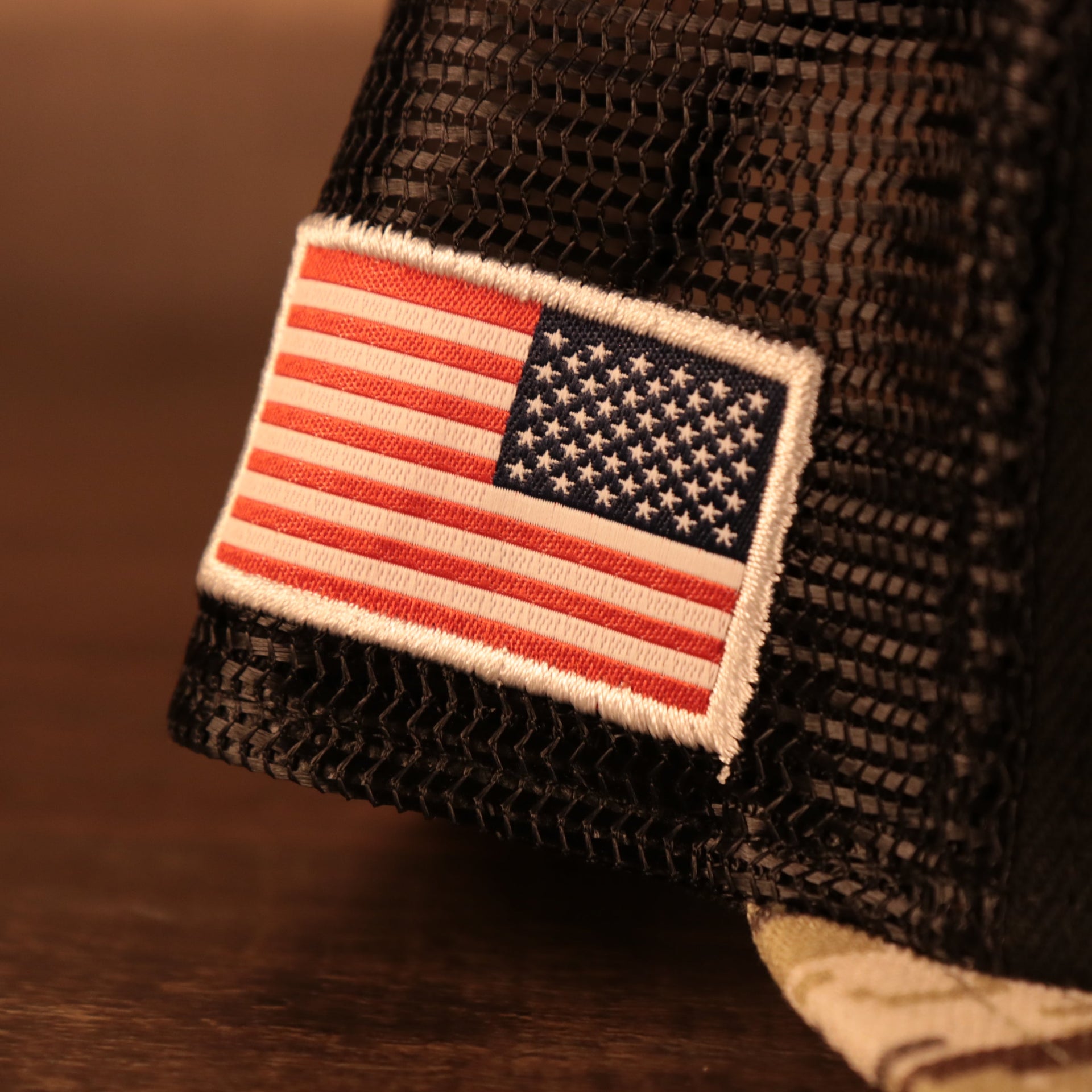 Close up of the USA Flag patch on the NFL Shield 2021 Salute To Service On Field Sideline 9Fifty Snapback Trucker Hat