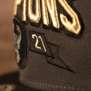 A close up of the 2021 embroidery on the front of the Milwaukee Bucks 2021 NBA Champions Trophy Locker Room 9Fifty Snapback hat