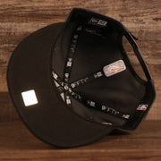 The under brim of the Milwaukee Bucks 2021 NBA Champions Trophy Locker Room 9Fifty Snapback Hat is black