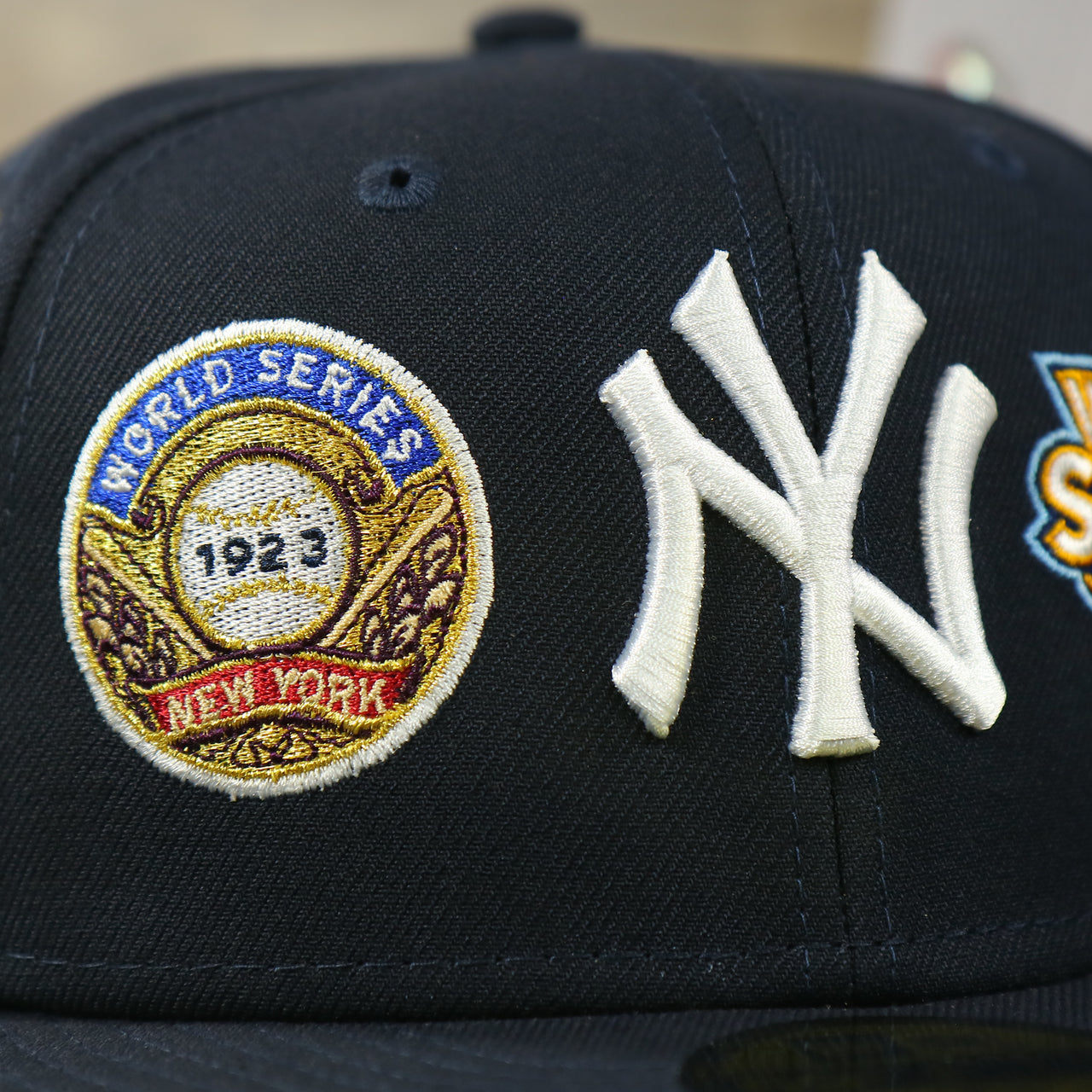 1923 world series patch and new york yankees logo on the New York Yankees Cooperstown All Over Side Patch "Historic Champs" Gray UV 59Fifty Fitted Cap | Navy 59Fifty Fitted Cap