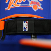NBA label on the New York Knicks "Team Script" College Bar Grey Bottom 9Fifty Snapback | Blue/Orange Knicks 950 Snap Cap