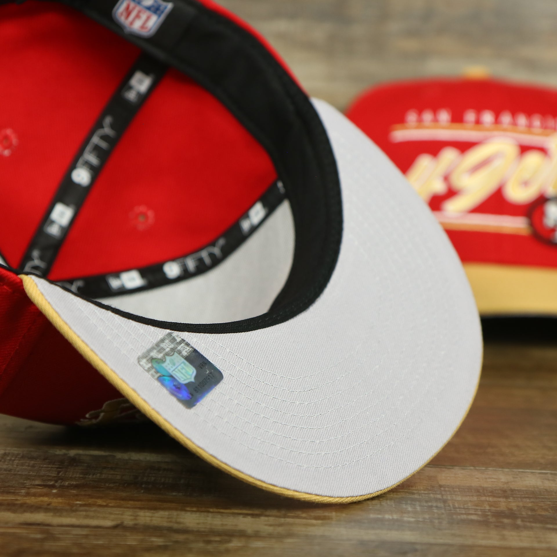 gray under visor of the San Francisco 49ers Team Script College Bar 9Fifty Snapback Hat | Red/Tan 49ers 950 Snap Cap