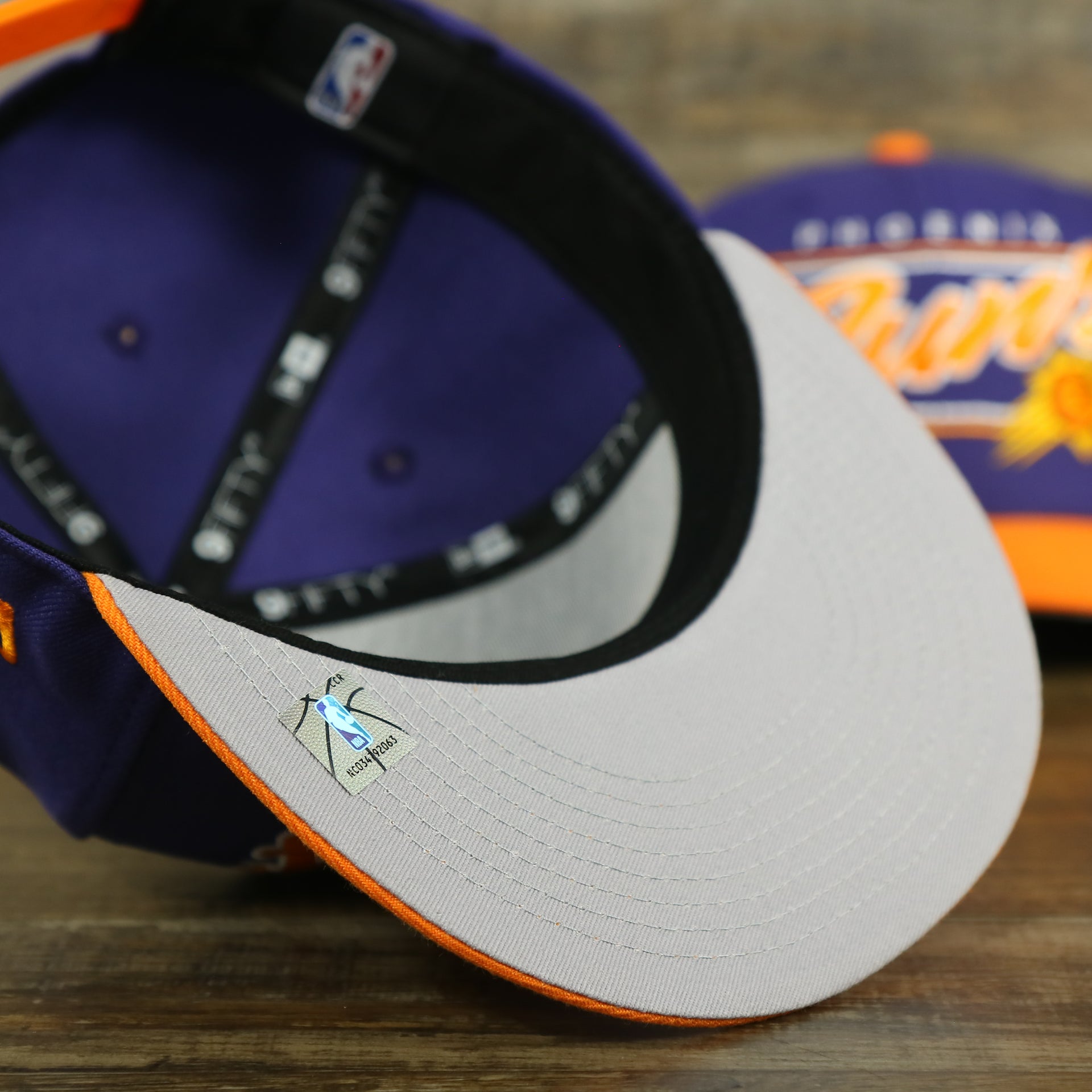 gray under visor on the Phoenix Suns Team Script College Bar 9Fifty Snapback Hat | Purple/Orange Suns 950 Snap Cap