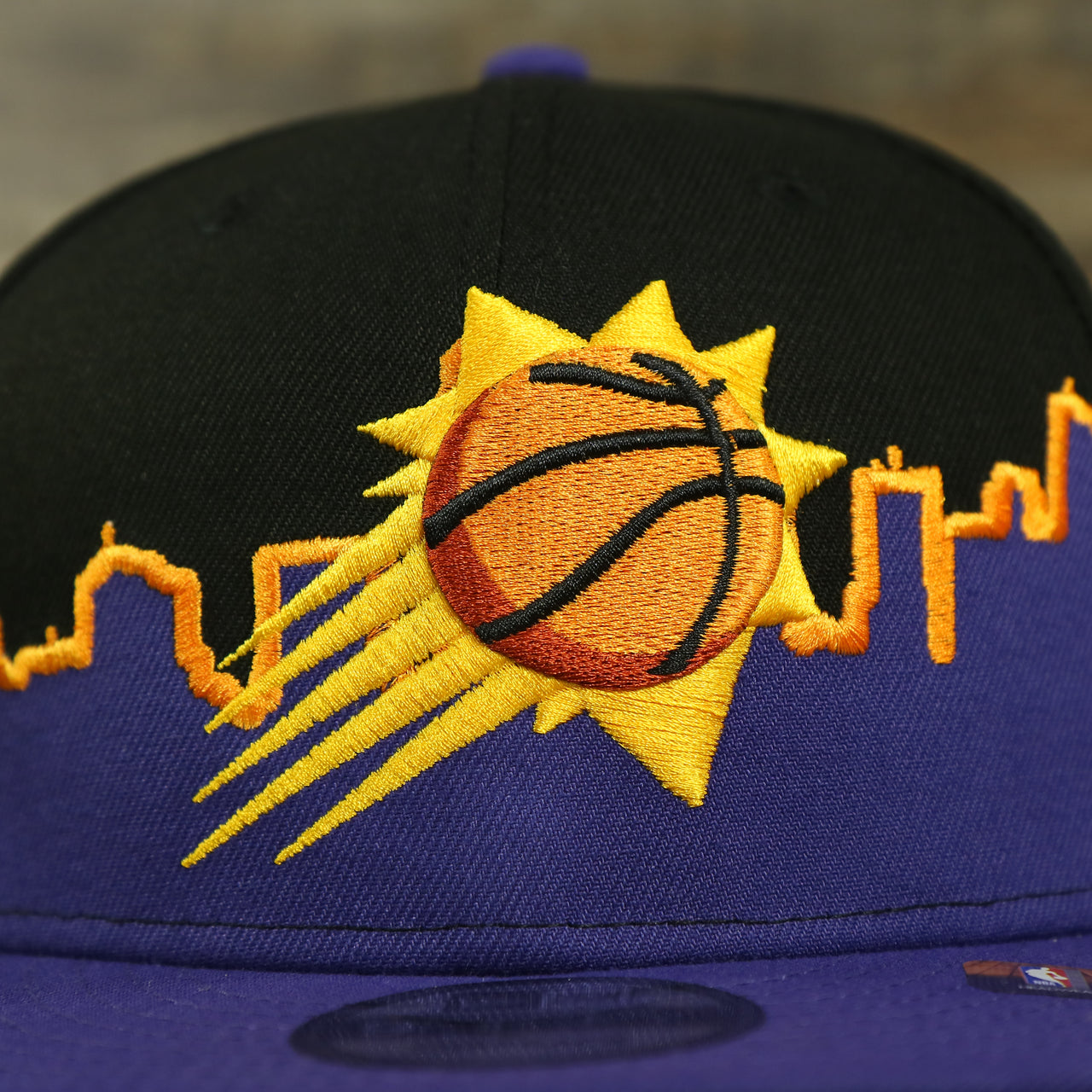 suns logo on the Phoenix Suns City Skyline Side Patch 9Fifty Snapback Hat | Phoenix Skyline 950