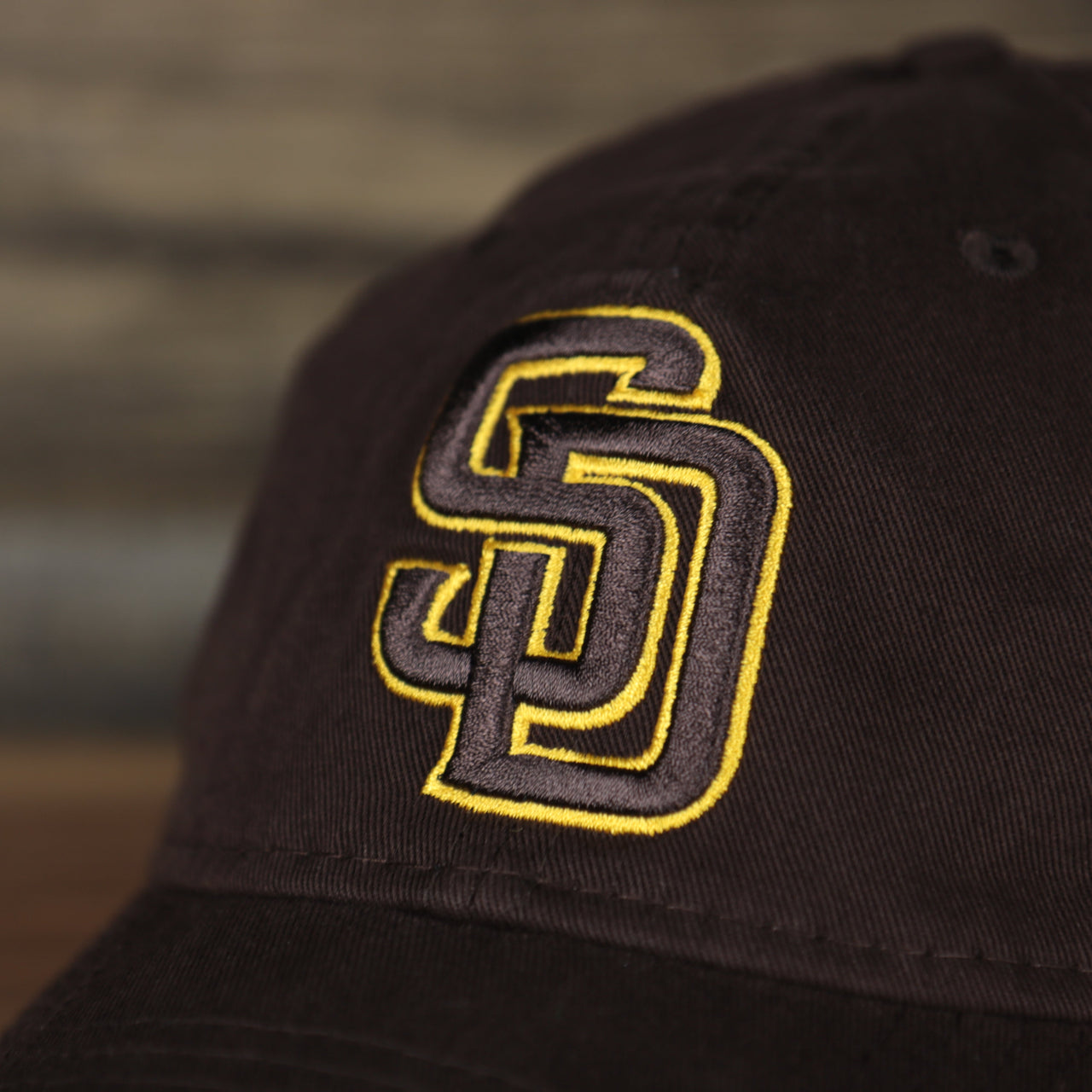 Close up of the San Diegoe Padres logo on the San Diego Padres 2022 MLB Batting Practice 9Twenty Trucker Dad Hat