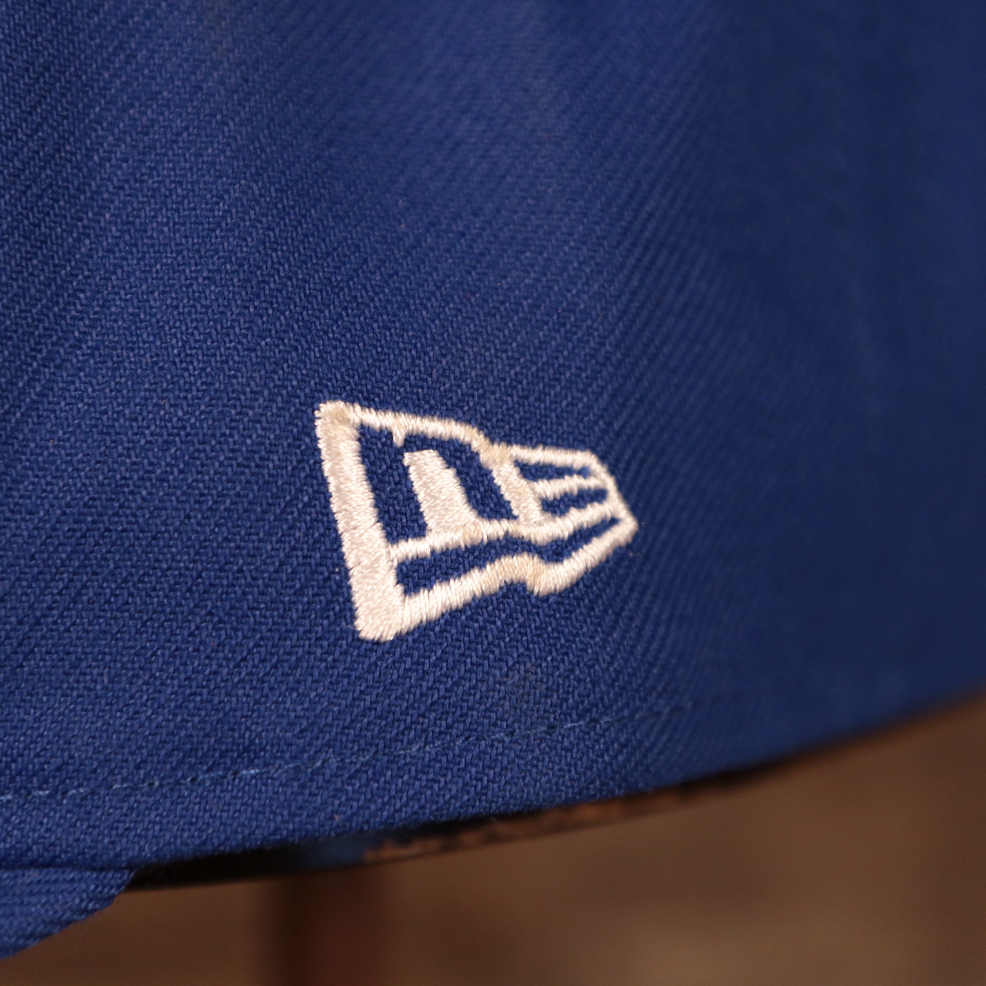 new era logo on the Philadelphia 76ers Blue Adjustable Grey Bottom Snapback