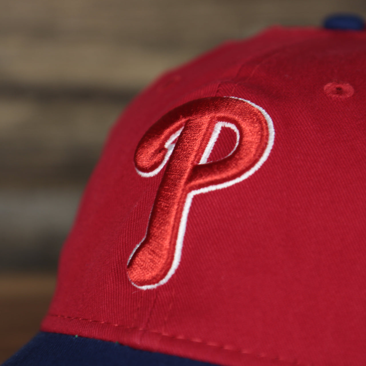Close up of the front logo on the Philadelphia Phillies 2022 MLB Batting Practice On-Field Spring Training 9Twenty Trucker Dad Hat