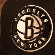 Close up of the Brooklyn Nets logo on the Brooklyn Nets City Transit All Over Side Patch Gray Bottom 59Fifty Fitted Cap