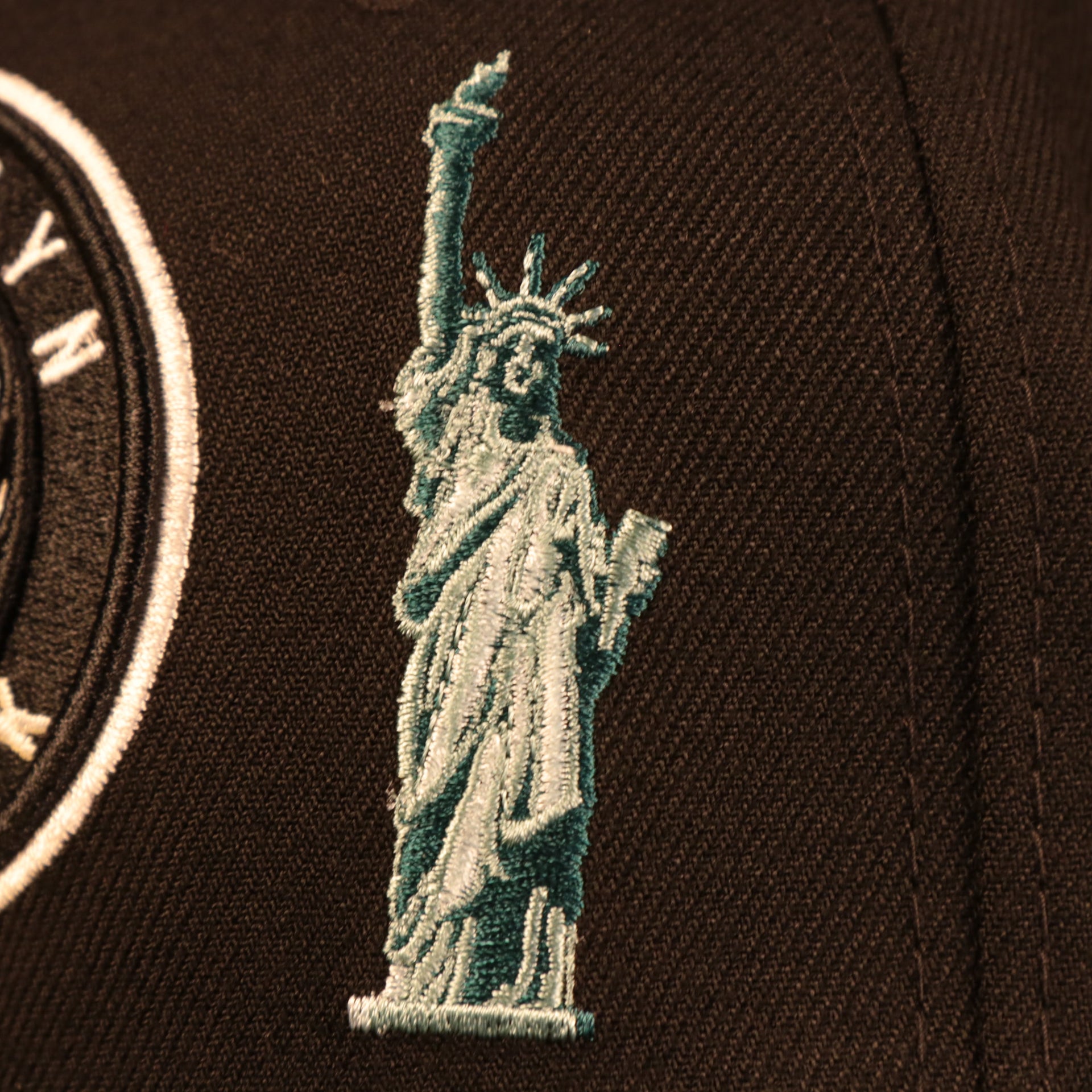 Close up of the Statue of Liberty logo on the Brooklyn Nets City Transit All Over Side Patch Gray Bottom 59Fifty Fitted Cap