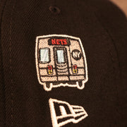 Close up of the subway car side patch and New Era logo on the Brooklyn Nets City Transit All Over Side Patch Gray Bottom 59Fifty Fitted Cap