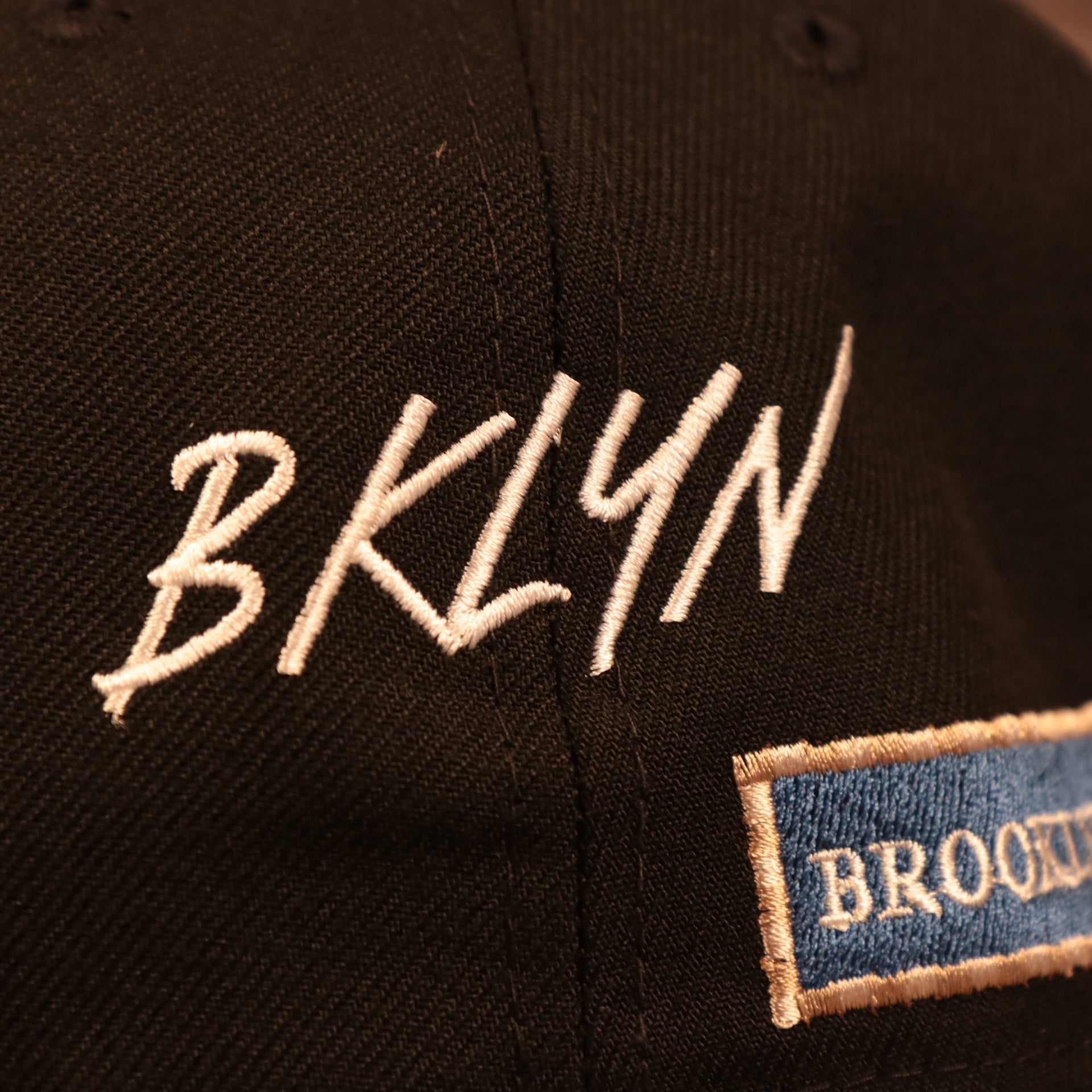 BKLYN lettering on the Brooklyn Nets City Transit All Over Side Patch Gray Bottom 59Fifty Fitted Cap