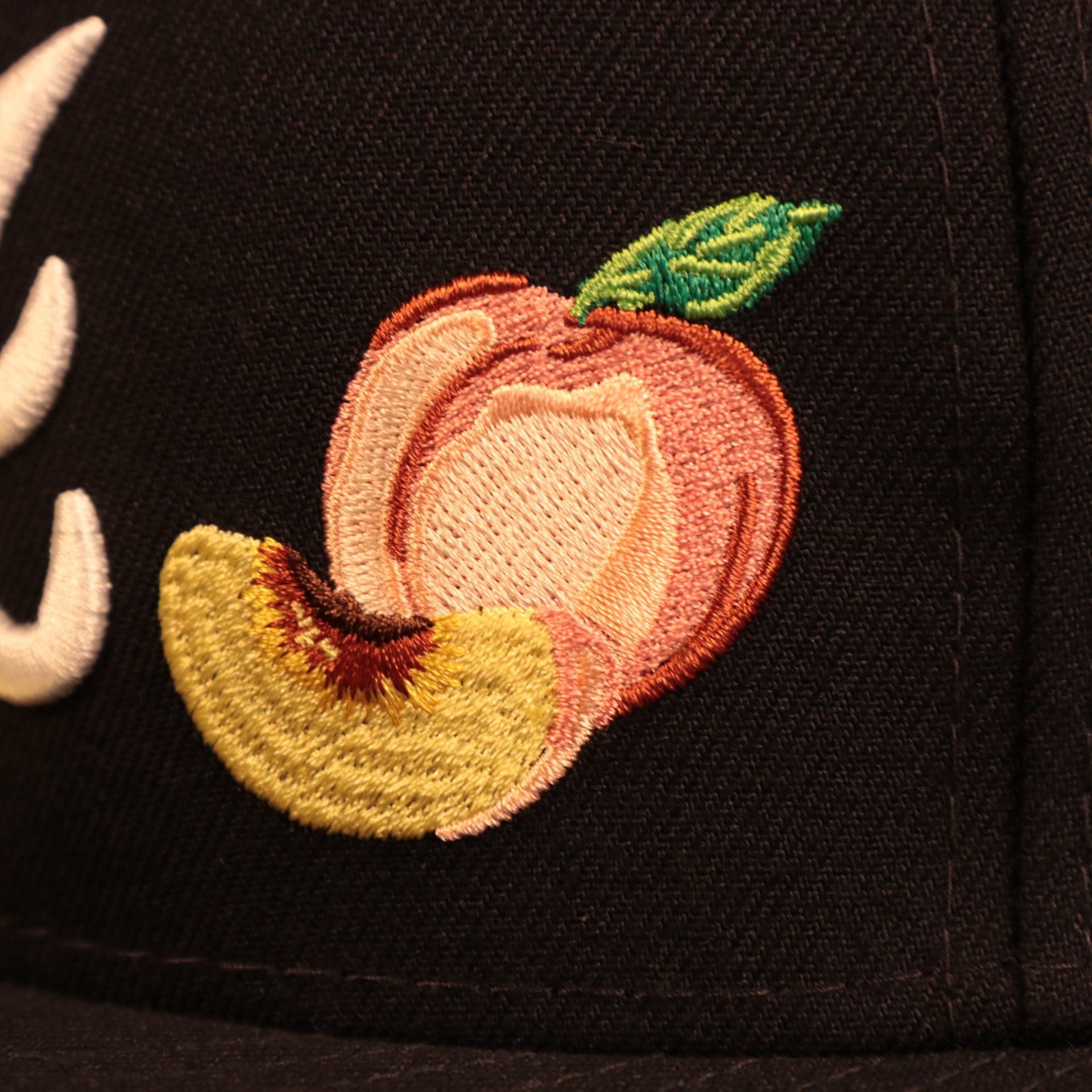 Close up of the peach patch embroidery on the Atlanta Braves City Transit All Over Side Patch Gray Bottom 59Fifty Fitted Cap
