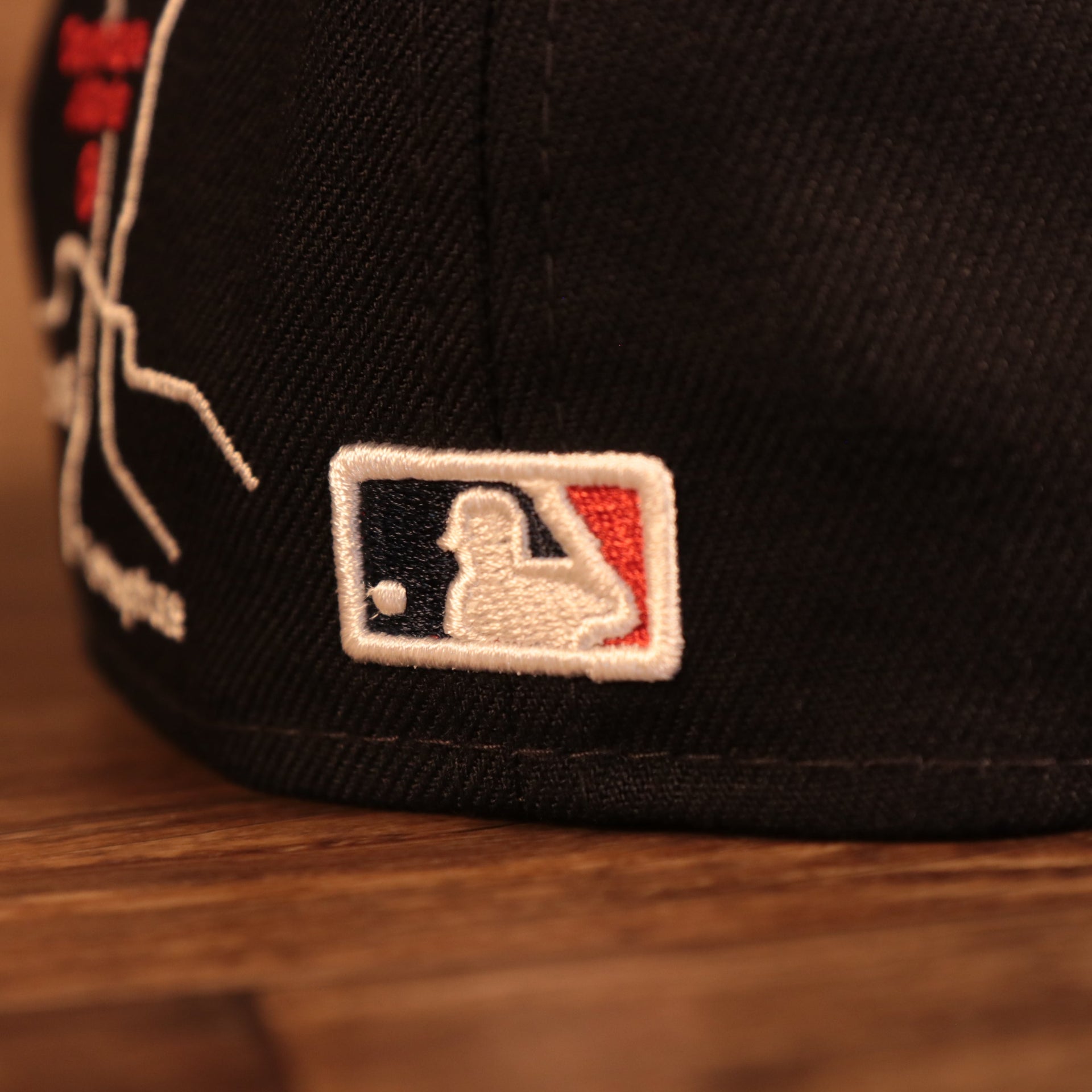 Close up of the MLB batterman logo on the back of the Atlanta Braves City Transit All Over Side Patch Gray Bottom 59Fifty Fitted Cap