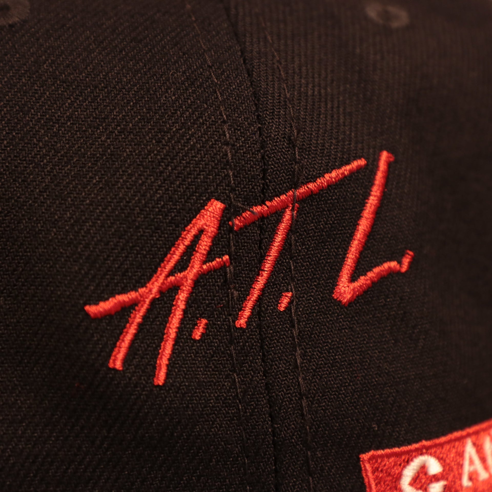 Close up of the A.T.L. script on the Atlanta Braves City Transit All Over Side Patch Gray Bottom 59Fifty Fitted Cap