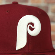 phillies logo on the Cooperstown Philadelphia Phillies Pop Sweat Pastel World Series Side Patch Fitted Cap With Purple Undervisor | Maroon 59Fifty Cap
