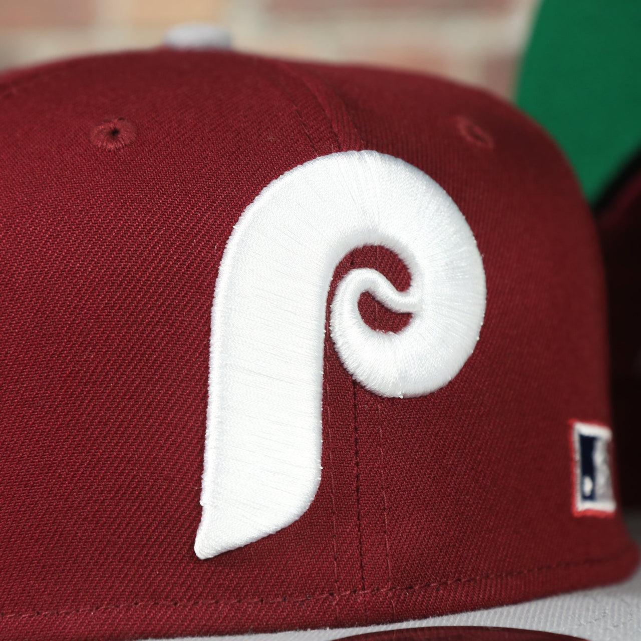 phillies logo on the Philadelphia Phillies Throwback Green Bottom White Back Letter Arch 9Fifty Snapback | Back Word Arch Maroon 9Fifty