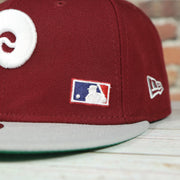 mlb logo on the Philadelphia Phillies Throwback Green Bottom White Back Letter Arch 9Fifty Snapback | Back Word Arch Maroon 9Fifty
