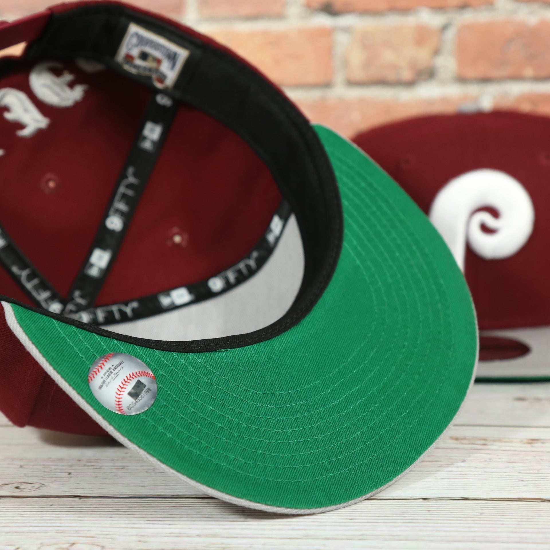 green under visor on the Philadelphia Phillies Throwback Green Bottom White Back Letter Arch 9Fifty Snapback | Back Word Arch Maroon 9Fifty