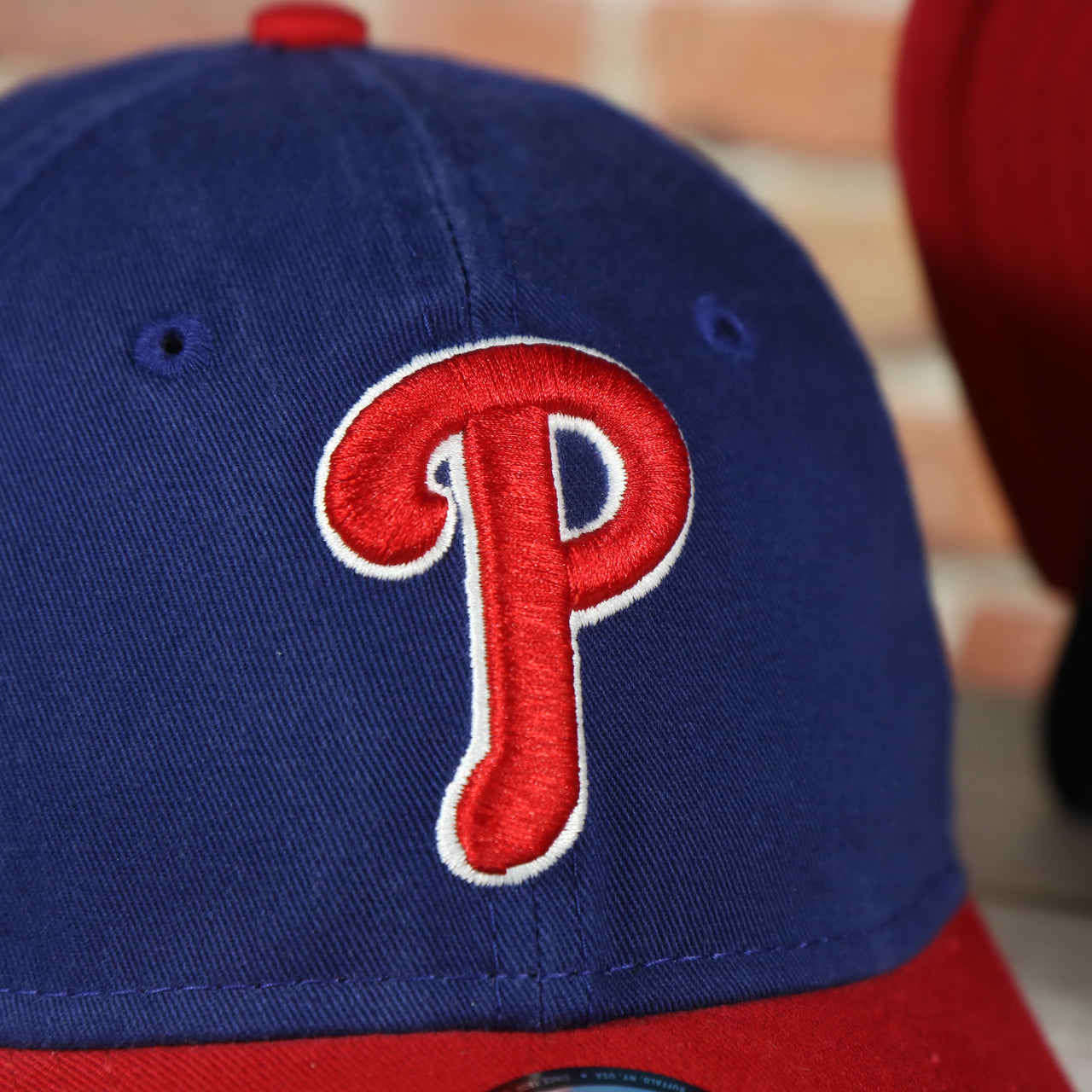 Close up of the two-tone Phillies logo on the Philadelphia Phillies Core Classic Youth Royal/Red 9Twenty Kid's Dad Hat