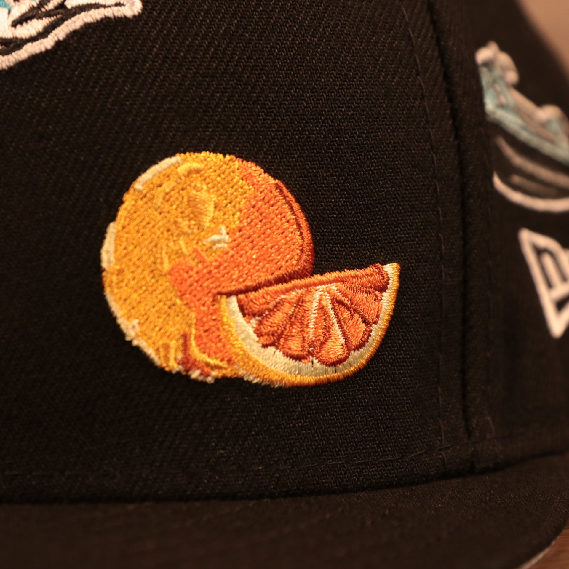Close up of the orange patch logo on the Florida Marlins Cooperstown City Transit All Over Side Patch Gray Bottom 59Fifty Fitted Cap