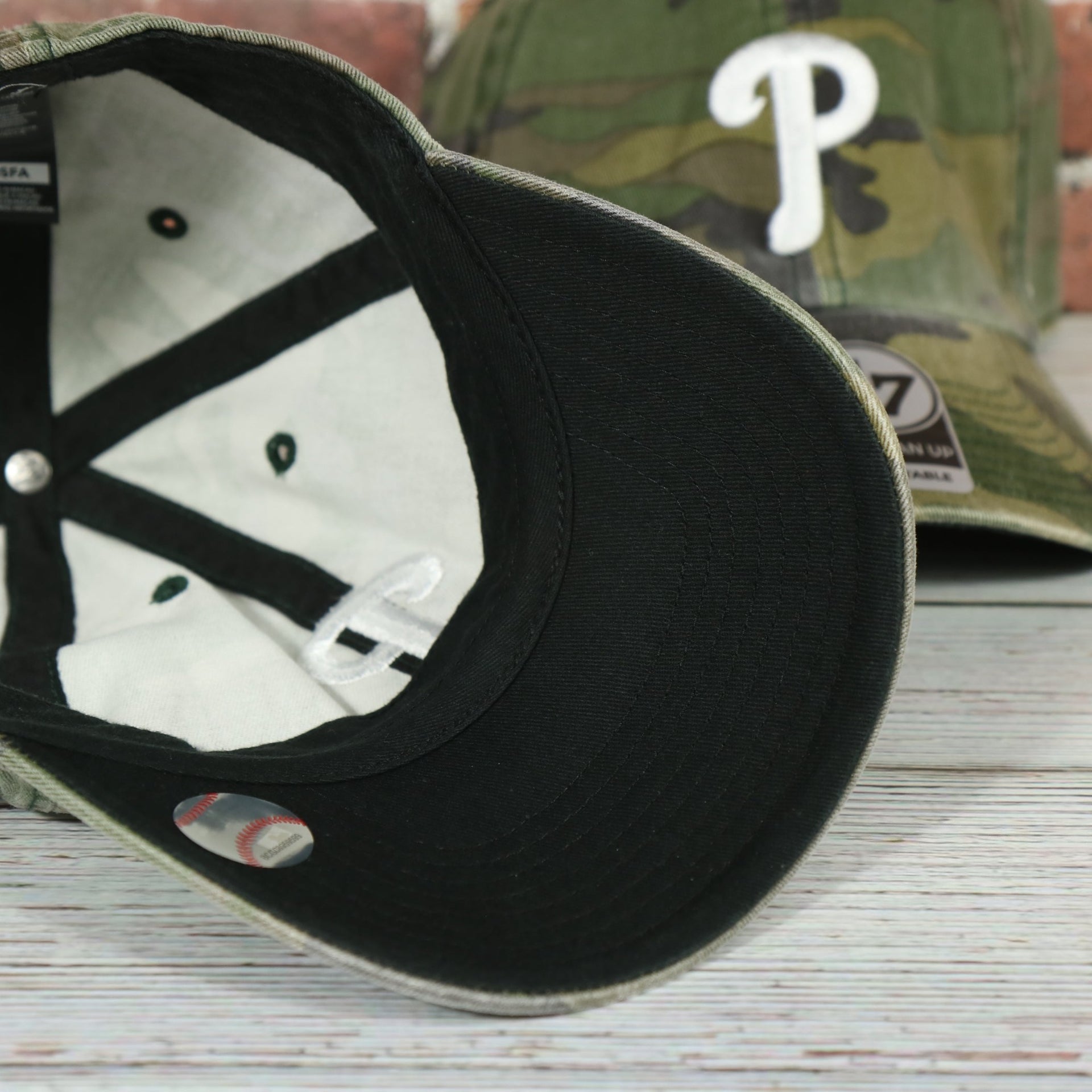 black under visor on the Philadelphia Phillies White Phillies Logo Camo Dad Hat | Camo Hat