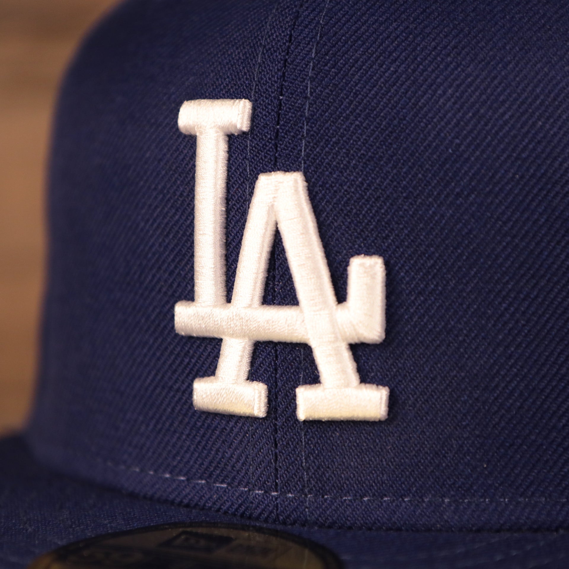 Close up of the Los Angeles Dodgers logo on the Los Angeles Dodgers 1980 All Star Game Crystal Side Patch Icy Blue Bottom 59Fifty Fitted Cap