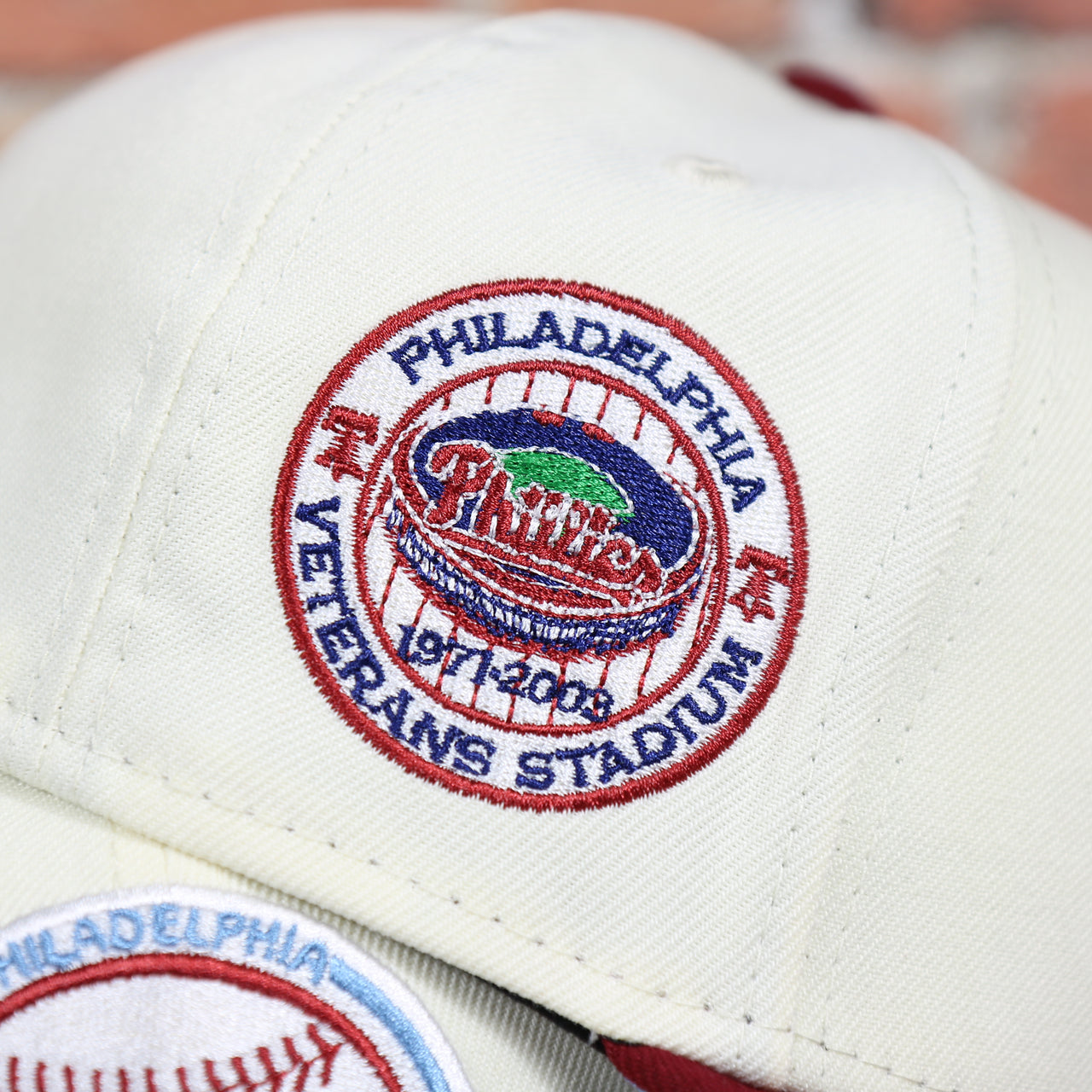 Close up of the Veterans Stadium on the Philadelphia Phillies Cooperstown City Hall Logo Veterans Stadium Side Patch Powder Blue UV 59Fifty Fitted Cap | Chrome/Maroon Cap Swag Exclusive