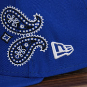 new era logo on the Philadelphia 76ers All Over Paisley Bandana Pattern Grey Bottom 5950 Fitted Cap | Blue