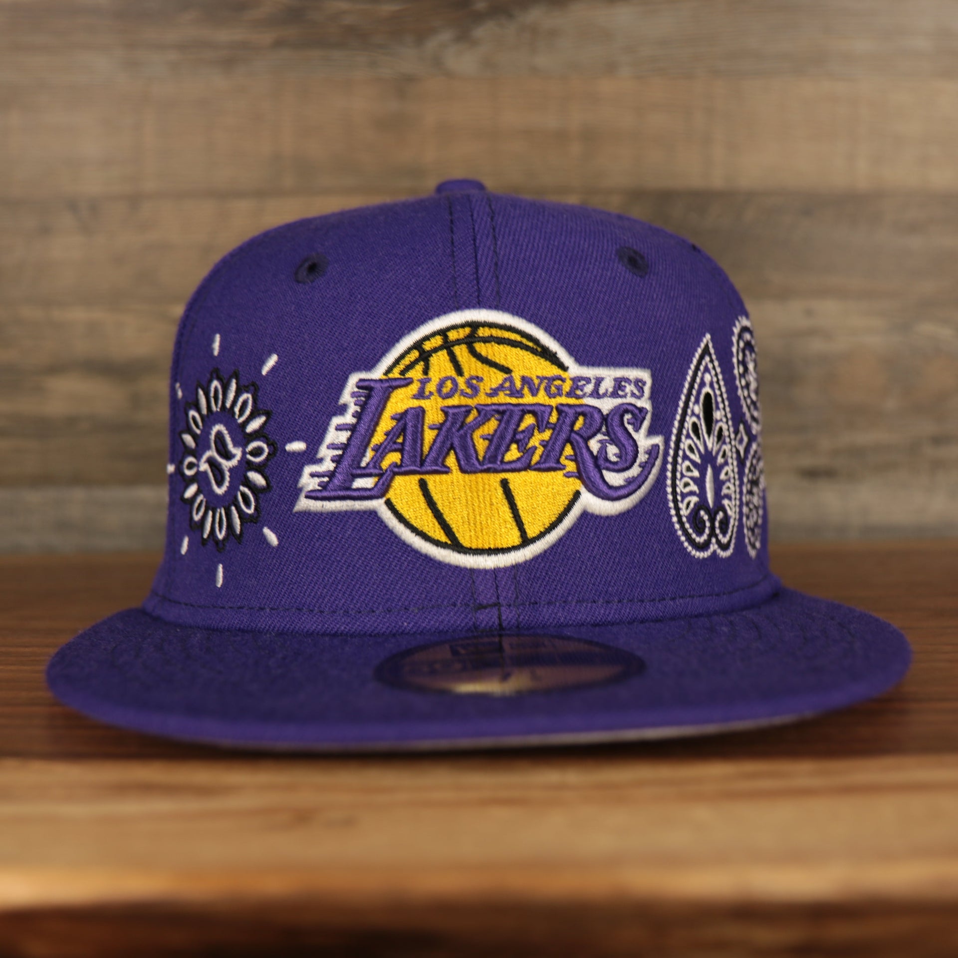 front of the Los Angeles Lakers All Over Paisley Bandana Pattern Grey Bottom 5950 Fitted Cap | Purple
