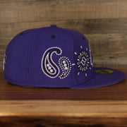 wearers right of the Los Angeles Lakers All Over Paisley Bandana Pattern Grey Bottom 5950 Fitted Cap | Purple