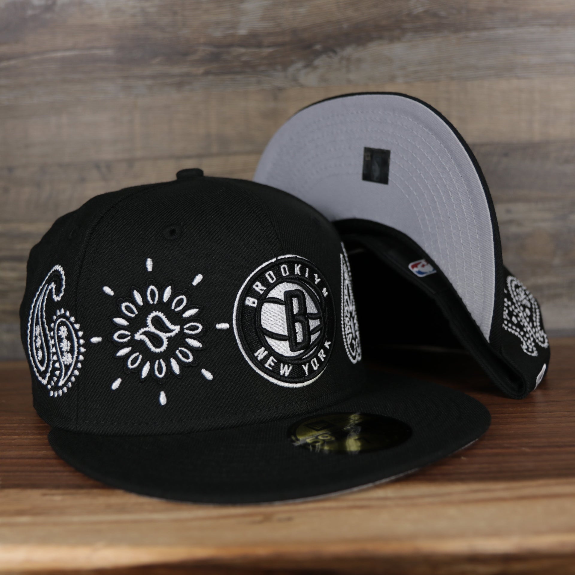 Front and bottom of the Brooklyn Nets All Over Paisley Bandana Pattern Grey Bottom 5950 Fitted Cap | Black