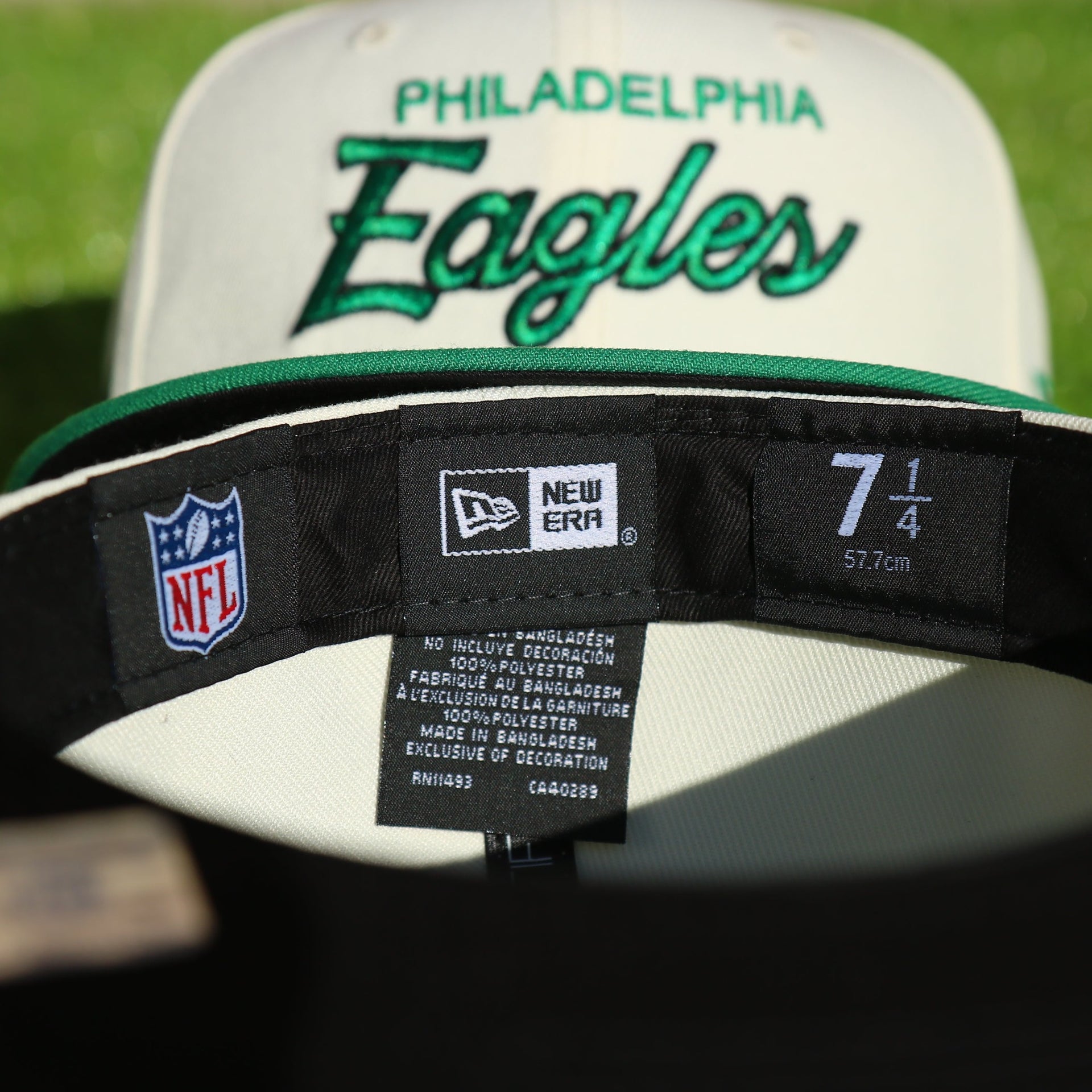 Labels on the interior of the Philadelphia Eagles Throwback Wordmark Jersey Script Cream/Kelly Green Black UV Side Patch 59Fifty Fitted Cap | Cap Swag Exclusive