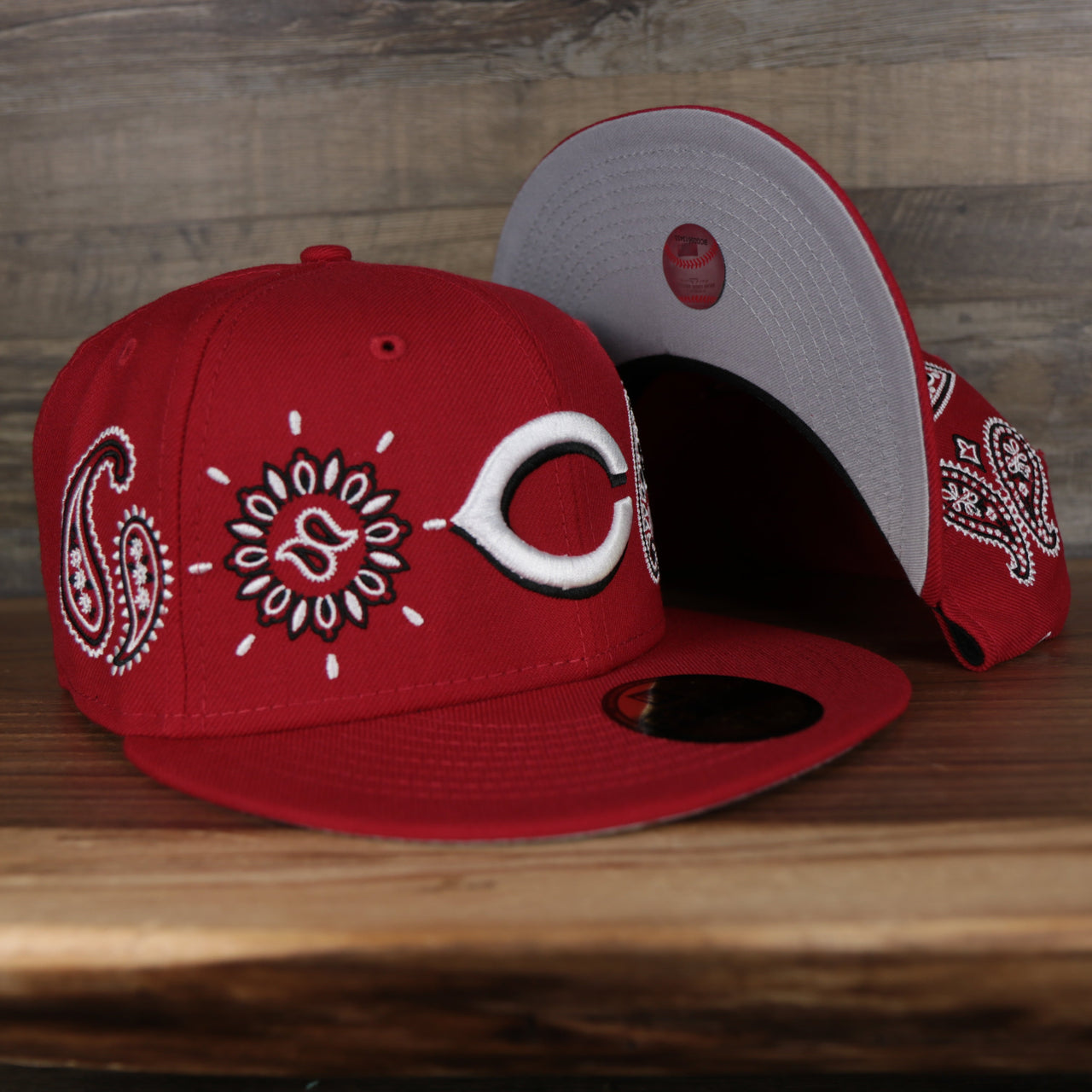 front and bottom of the Cincinnati Reds All Over Paisley Bandana Pattern Grey Bottom 5950 Fitted Cap | Red