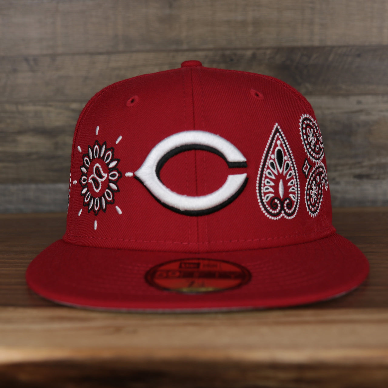 front of the Cincinnati Reds All Over Paisley Bandana Pattern Grey Bottom 5950 Fitted Cap | Red