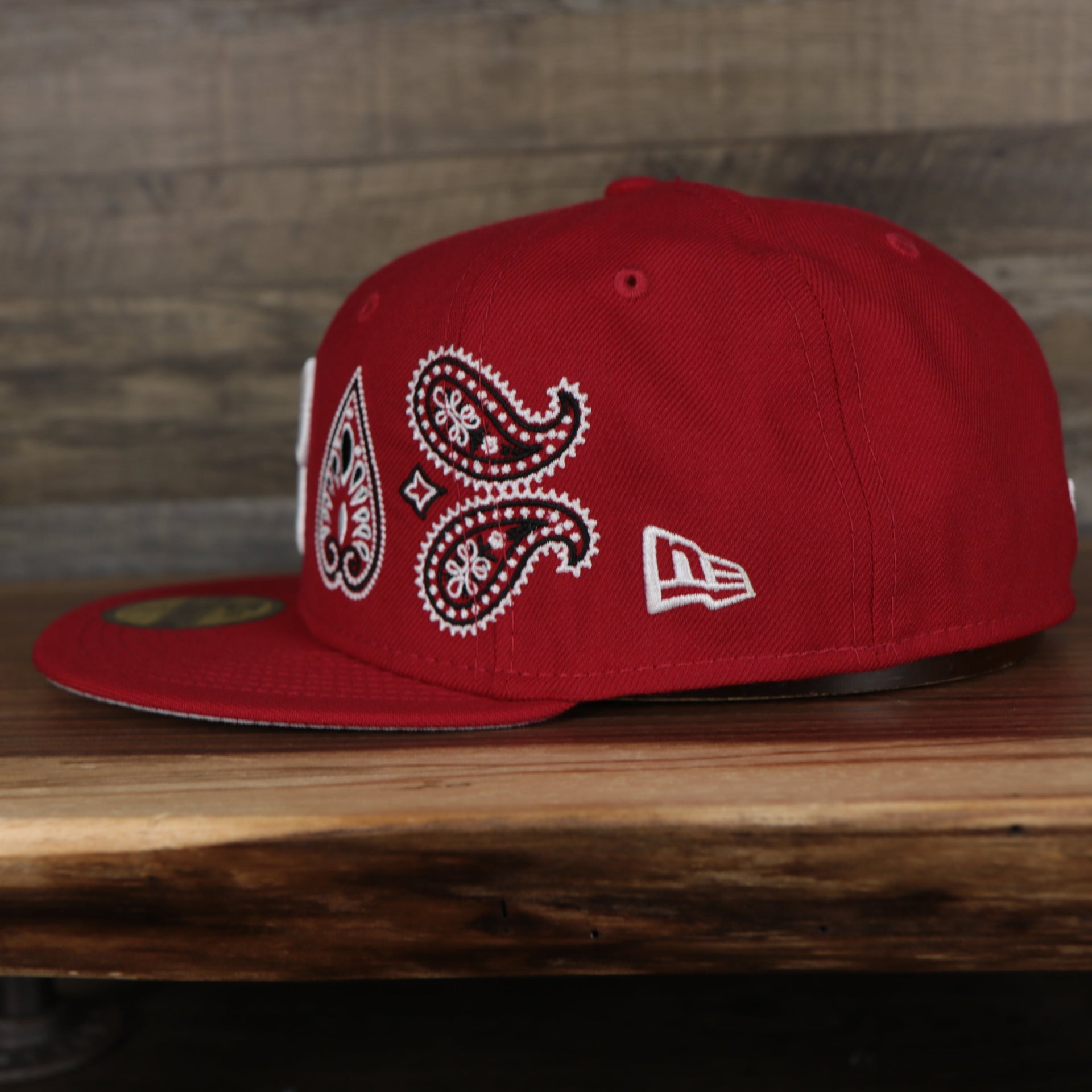 wearers left side of the Philadelphia Phillies All Over Paisley Bandana Pattern Grey Bottom Red 5950 Fitted Cap | Bandana Paisley