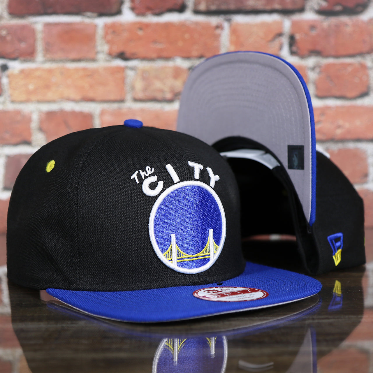 front and bottom of the Golden State Warriors Gray Bottom 9Fifty Snapback Cap | Black