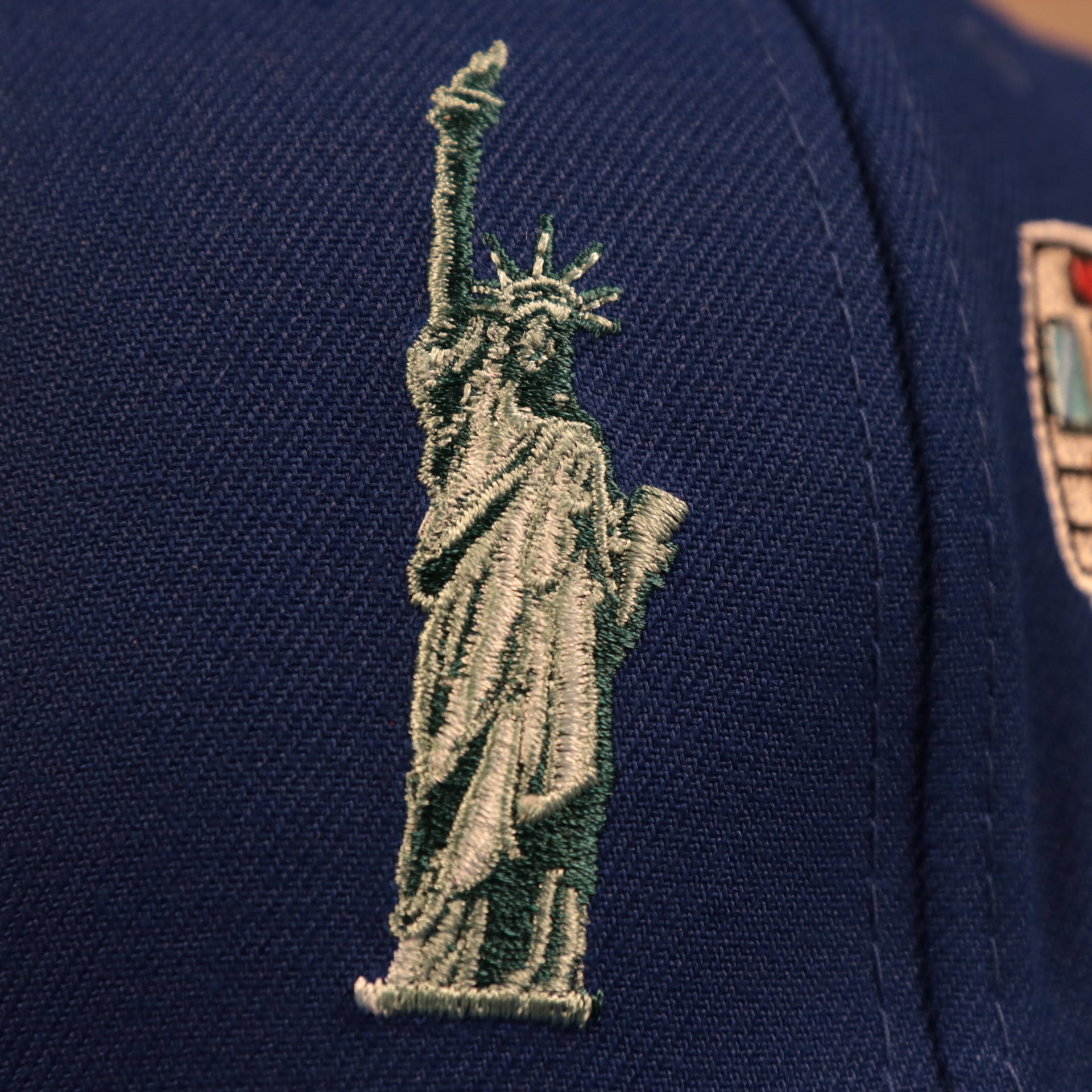 Close up of the Statue of Liberty logo on the New York Mets City Transit All Over Side Patch Gray Bottom 59Fifty Fitted Cap